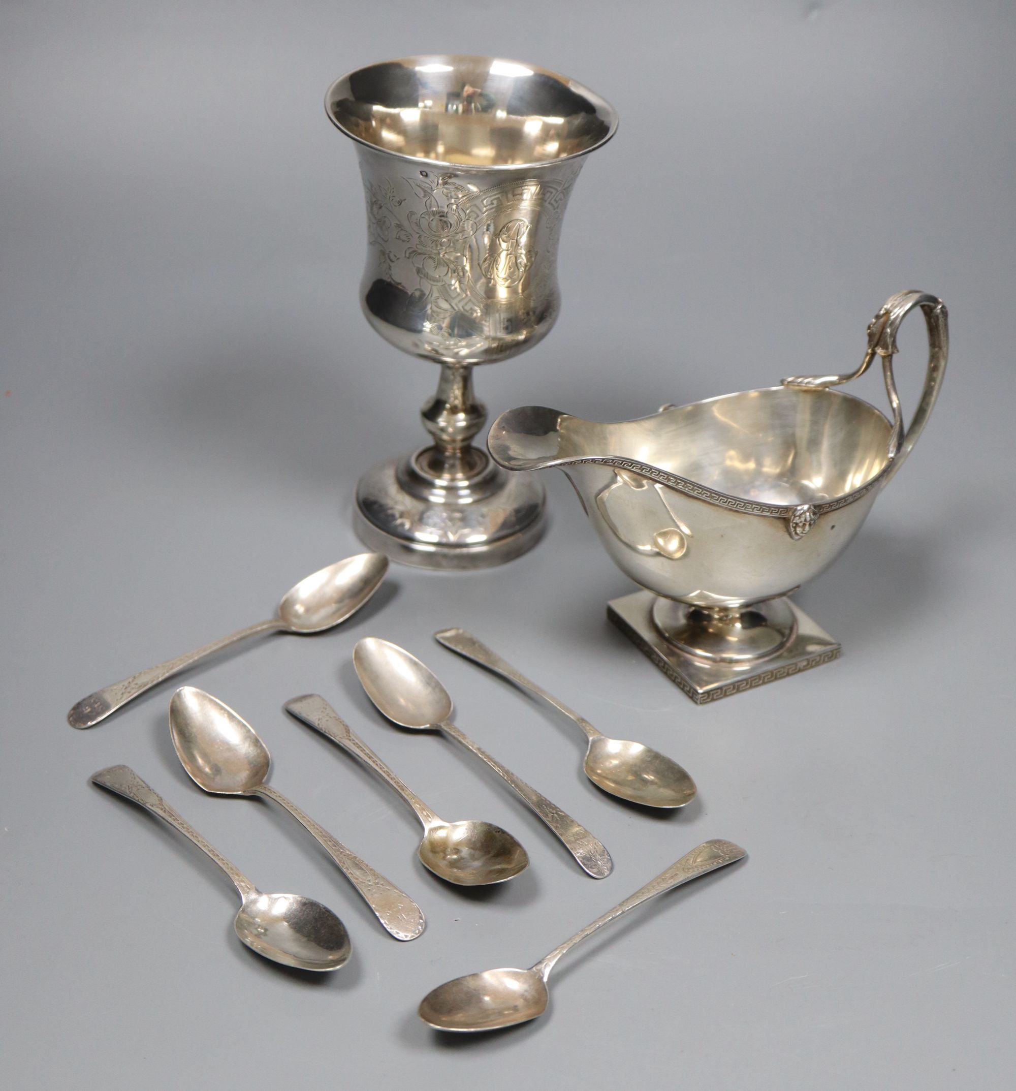 A George V silver sauceboat, a French white metal goblet(repaired) and seven assorted 19th century silver teaspoons,
